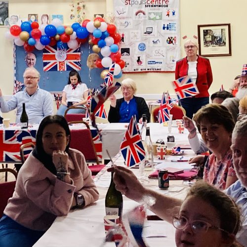 Flag-waving at the Coronation indoor street party